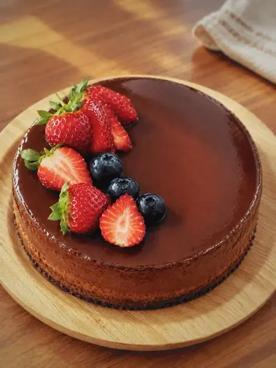 Crème caramel flan topped with strawberries and blueberries